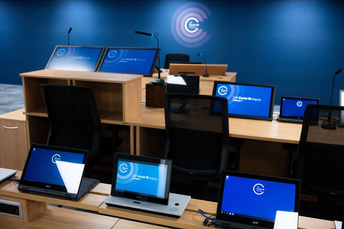 Bereaved families hold pictures of loved ones in vigil outside Covid inquiry