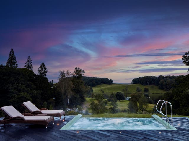 <p>The outdoor infinity pool at Coniston Hotel overlooks rolling hills and a tranquil lake </p>