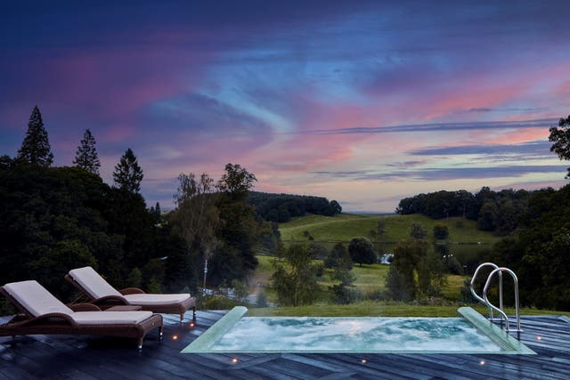 <p>The outdoor infinity pool at Coniston Hotel overlooks rolling hills and a tranquil lake </p>