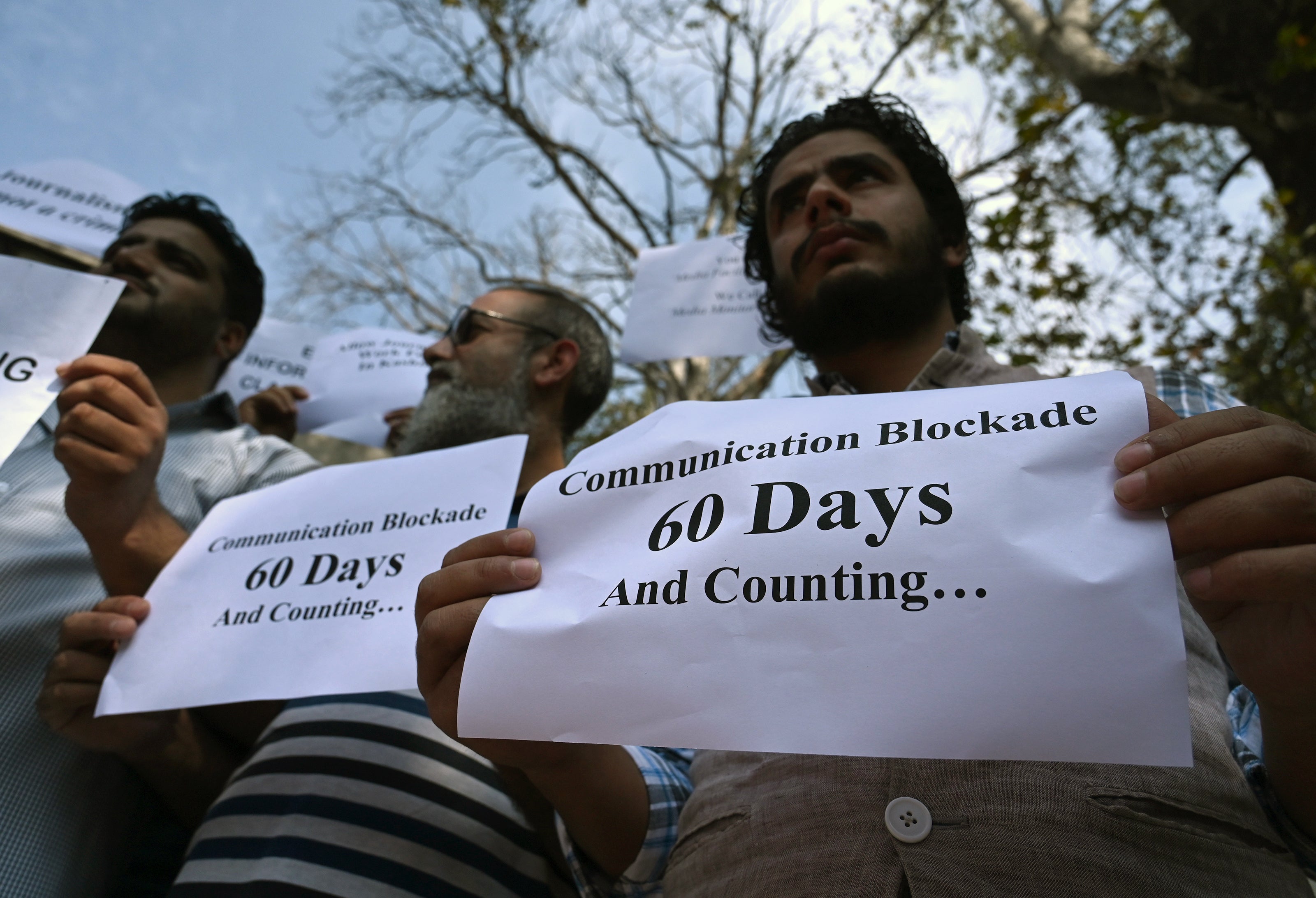 Journalists hold signs during a protest against the restrictions of the Internet and mobile phone networks at the Kashmir Press Club during a lockdown in Srinagar in 2019