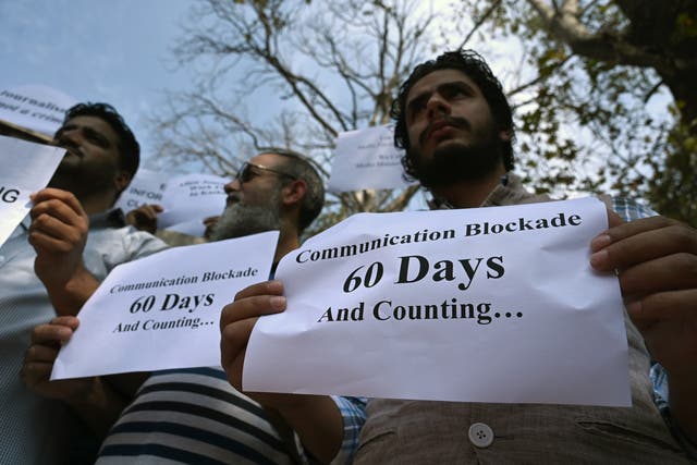 <p>Journalists hold signs during a protest against the restrictions of the Internet and mobile phone networks at the Kashmir Press Club during a lockdown in Srinagar in 2019 </p>