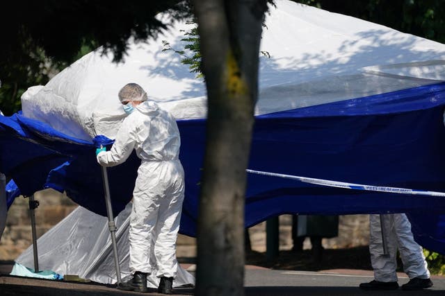 Police forensics officers erect a forensic tent on Magdala Road, Nottingham (Jacob King/PA)