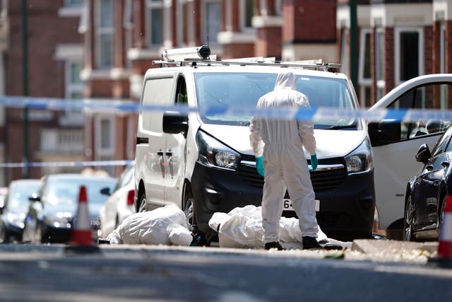 Police forensics officers search a white van on the corner of Maples Street and Bentinck Road in Nottingham. (Zac Goodwin/PA)