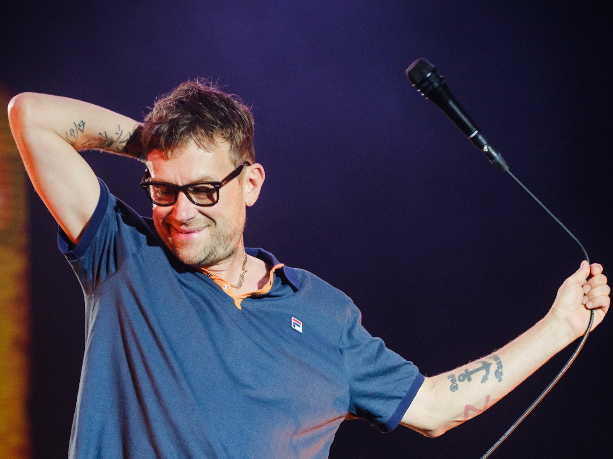 Blur’s Damon Albarn does his best to bring some energy back into the arena after a downpour