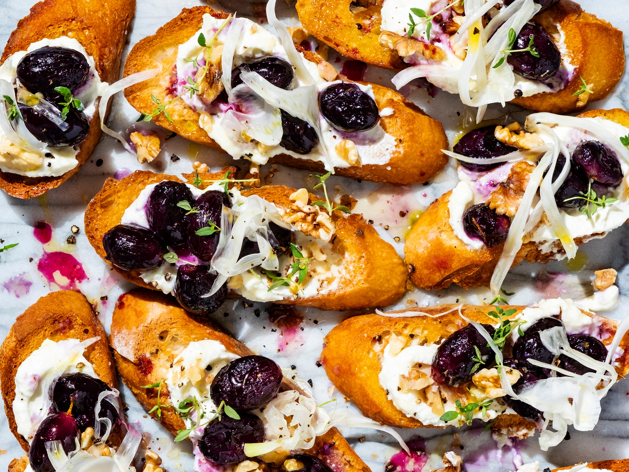 Crispy slices of baguette topped with creamy feta and succulent grapes