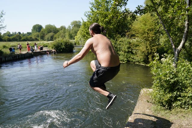 Keeping cool on the river Itchen near Twyford in Hampshire (Andrew Matthews/PA)