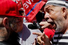 Chaos erupts as protester in prison garb jumps in front of Trump motorcade