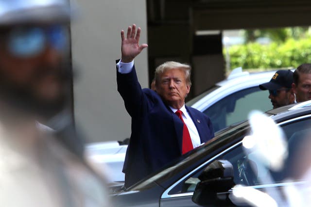 <p>Former president Donald Trump waves as he makes a visit to the Cuban restaurant Versailles after he appeared for his arraignment on 13 June 2023 in Miami, Florida</p>