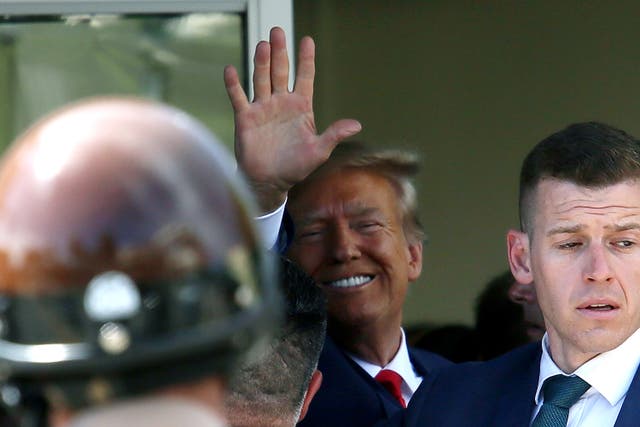 <p>Former US President Donald Trump waves as he makes a visit to the Cuban restaurant Versailles after he appeared for his arraignment on 13 June, 2023 in Miami, Florida</p>