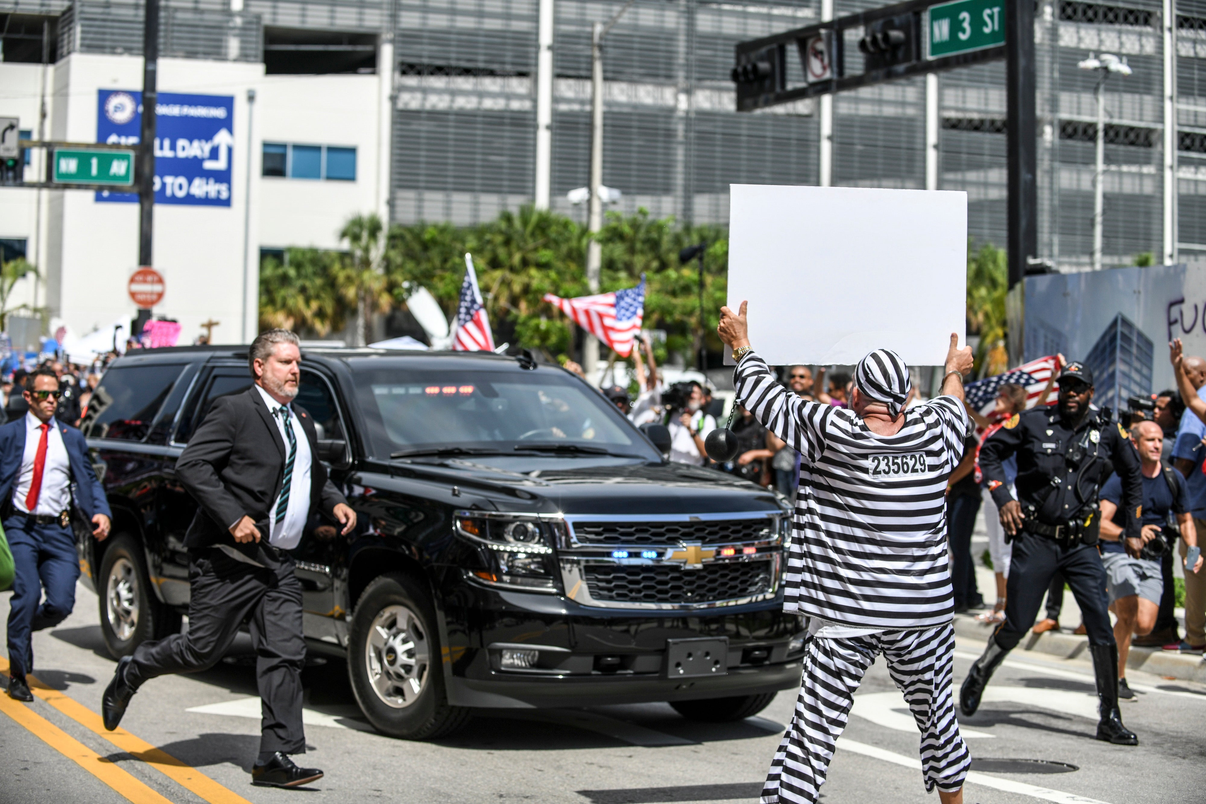 Dramatic moment protestor Domenic Santana of Miami, Florida, runs out in front of former President Donald Trump’s motorcade