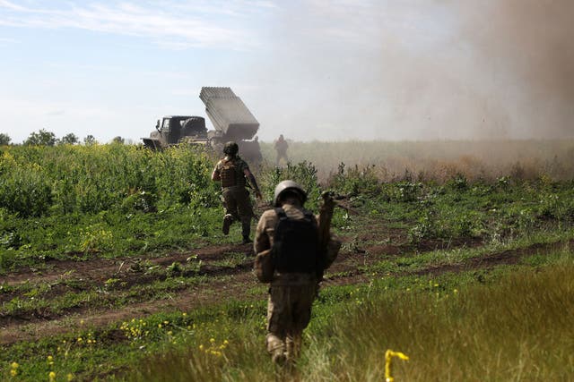 <p>Ukrainian servicemen shift position after firing rockets from a BM-21 ‘Grad’ multiple rocket launcher towards Russian positions, near Bakhmut in the Donetsk region</p>