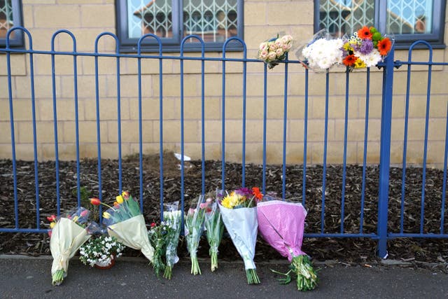 Flowers left outside a building on Ilkeston Road, Nottingham, after three people were killed and another three hurt in connected attacks on Tuesday morning (Jacob King/PA)