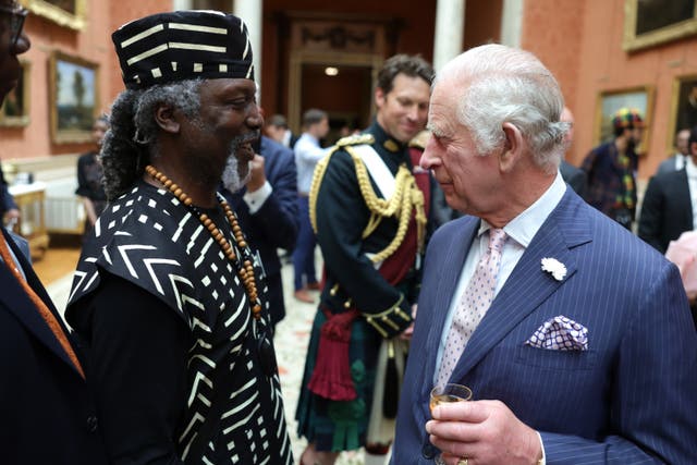 Charles speaks with a guest during a reception at Buckingham Palace to celebrate the Windrush generation (Chris Jackson/PA)