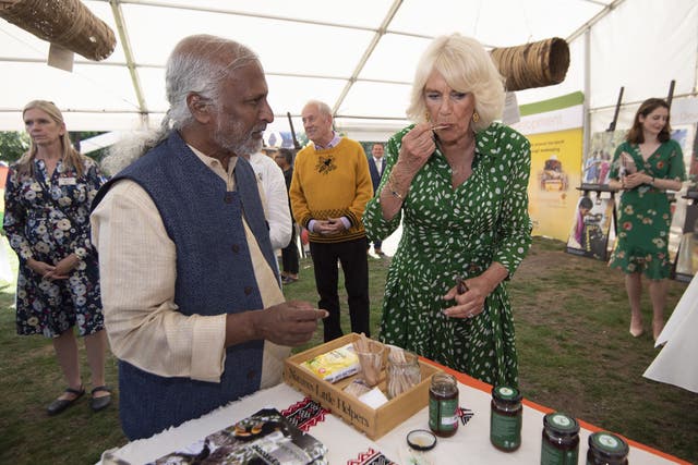 Queen Camilla tasted honey during the Bees For Development event (Eddie Mulholland/Daily Telegraph/PA)