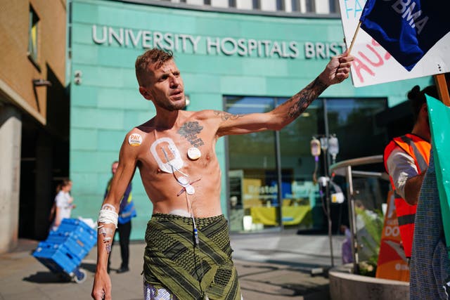 Patient Luke Rovira joins striking junior doctors on the picket line outside Bristol Royal Infirmary on Wednesday (PA)