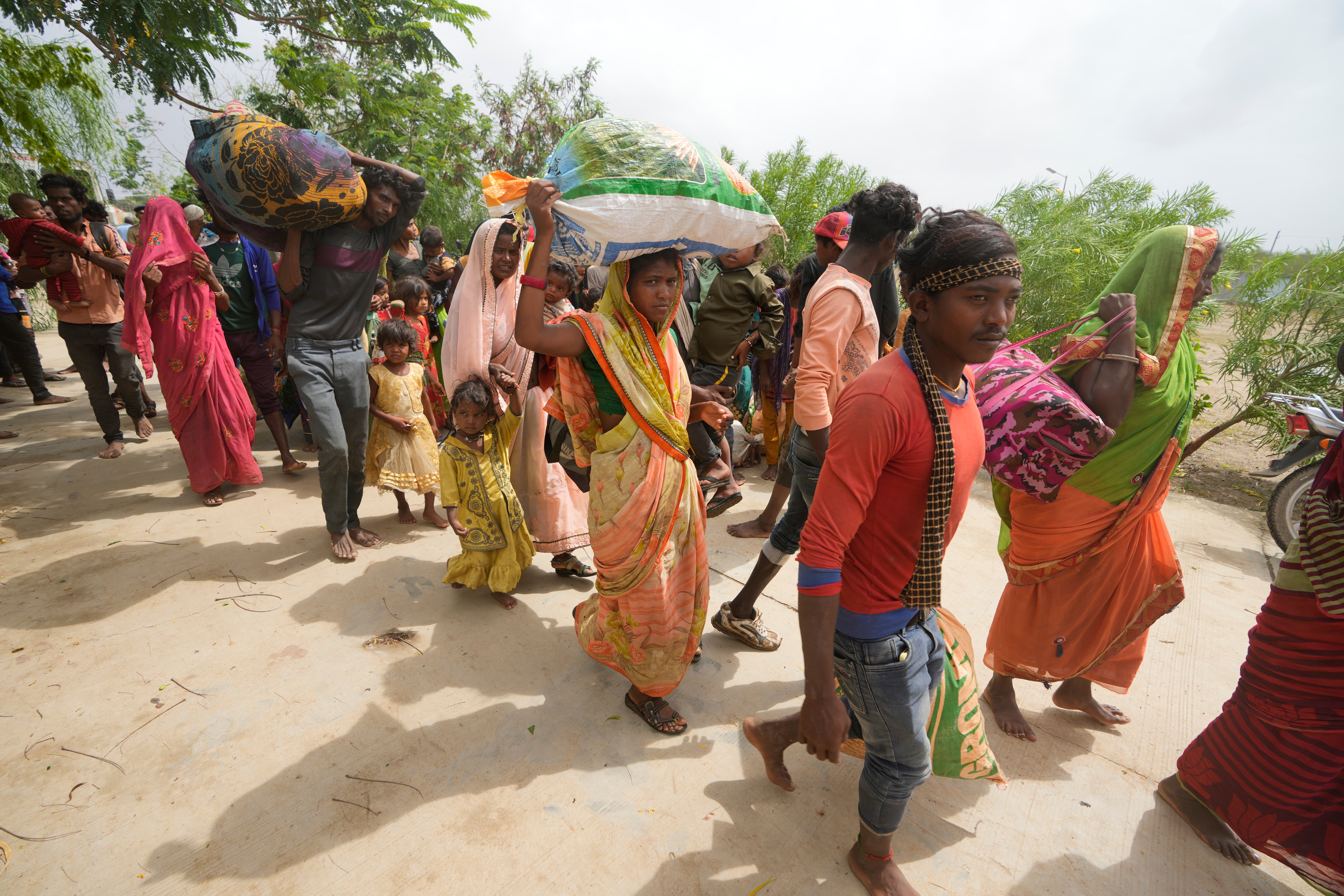 People evacuated from a village near Jakhau ahead of cyclone Biparjoy arrive at a shelter at Naliya in Kutch district of the Western Indian state of Gujarat