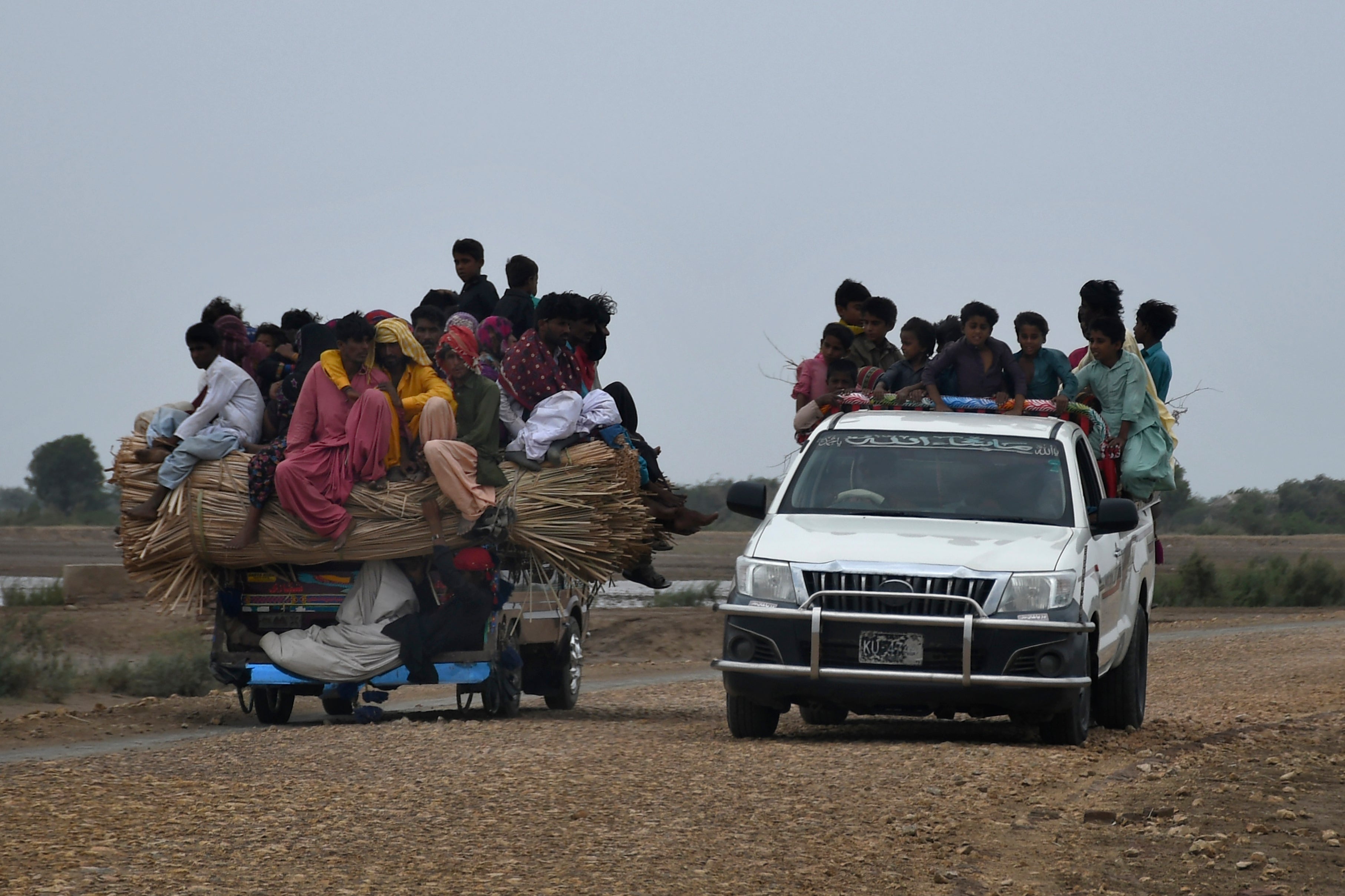 Local residents travel on a vehicle as they flee from a coastal village due to Cyclone Biparjoy approaching, in Golarchi near Badin, Pakistan's southern district in the Sindh province