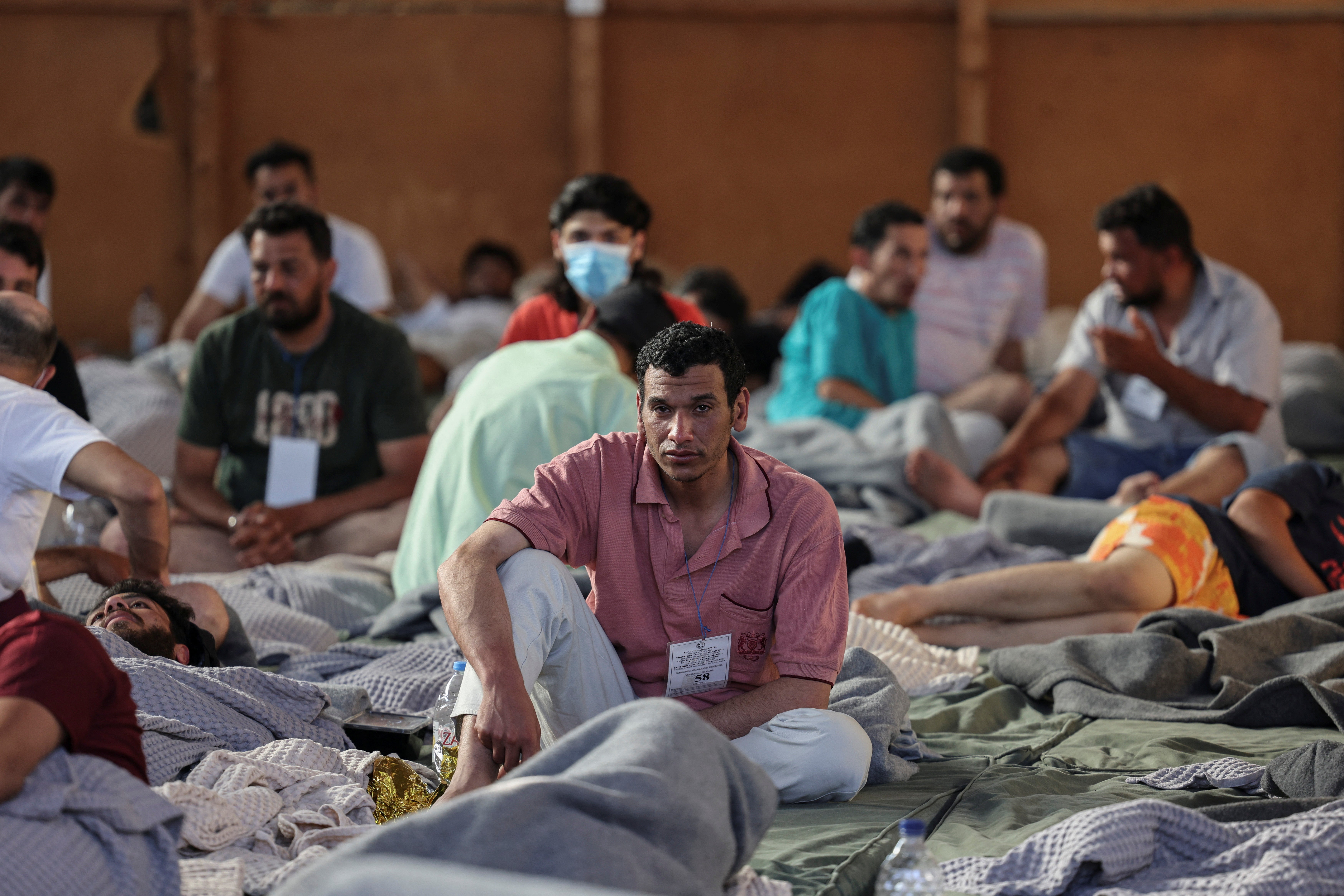 Migrants rest in a shelter in Kalamata, Greece, following their rescue from the Mediterranean