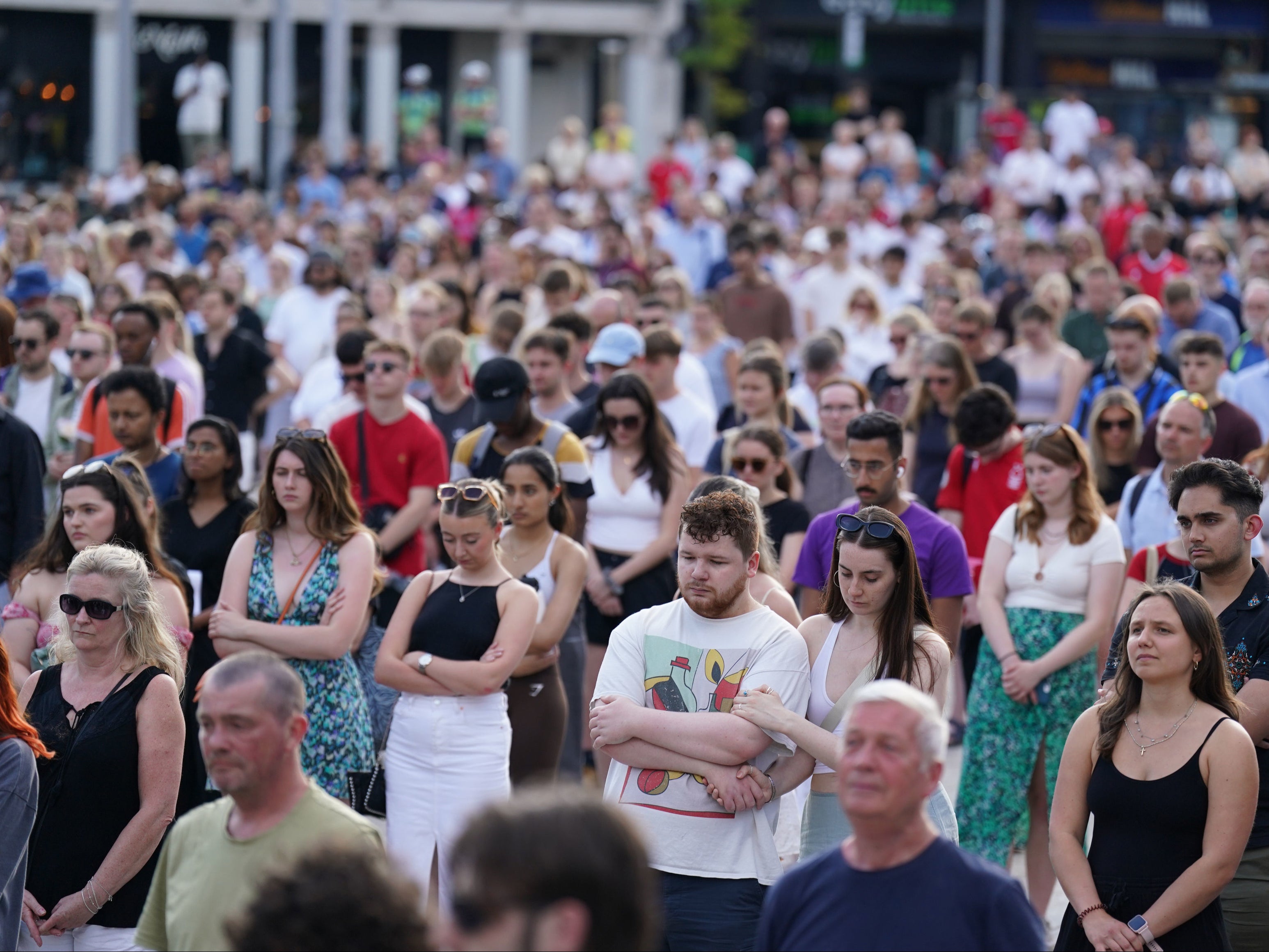 <p>Thousands joined the victims’ families in holding a minute’s silence at Nottingham’s Market Square </p>