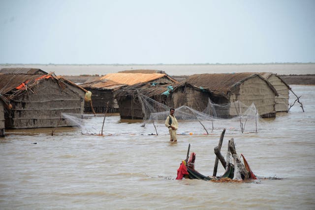 <p>A cyclone affected man wades through water as cyclone Biparjoy rises sea level in a coastal area in Sujawal of Pakistan's Sindh province</p>