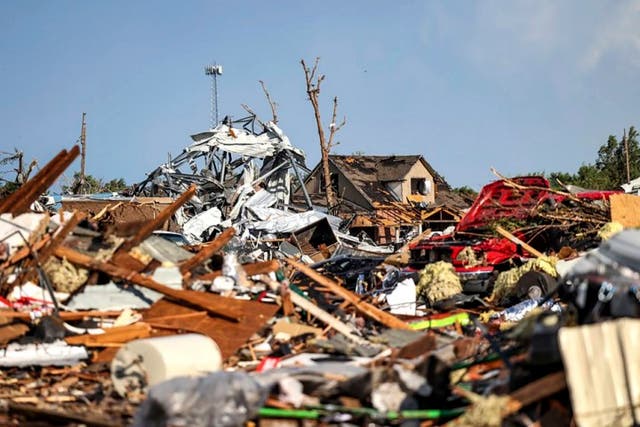 <p>Debris covers a residential area in Perryton, Texas, after a tornado struck the town on Thursday </p>
