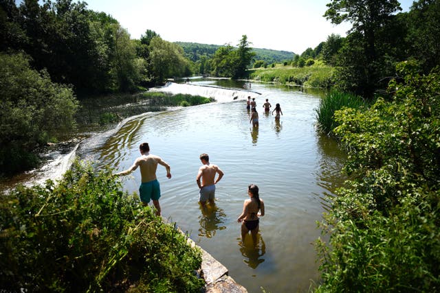 <p>People in the water at Warleigh Weir near Bath</p>