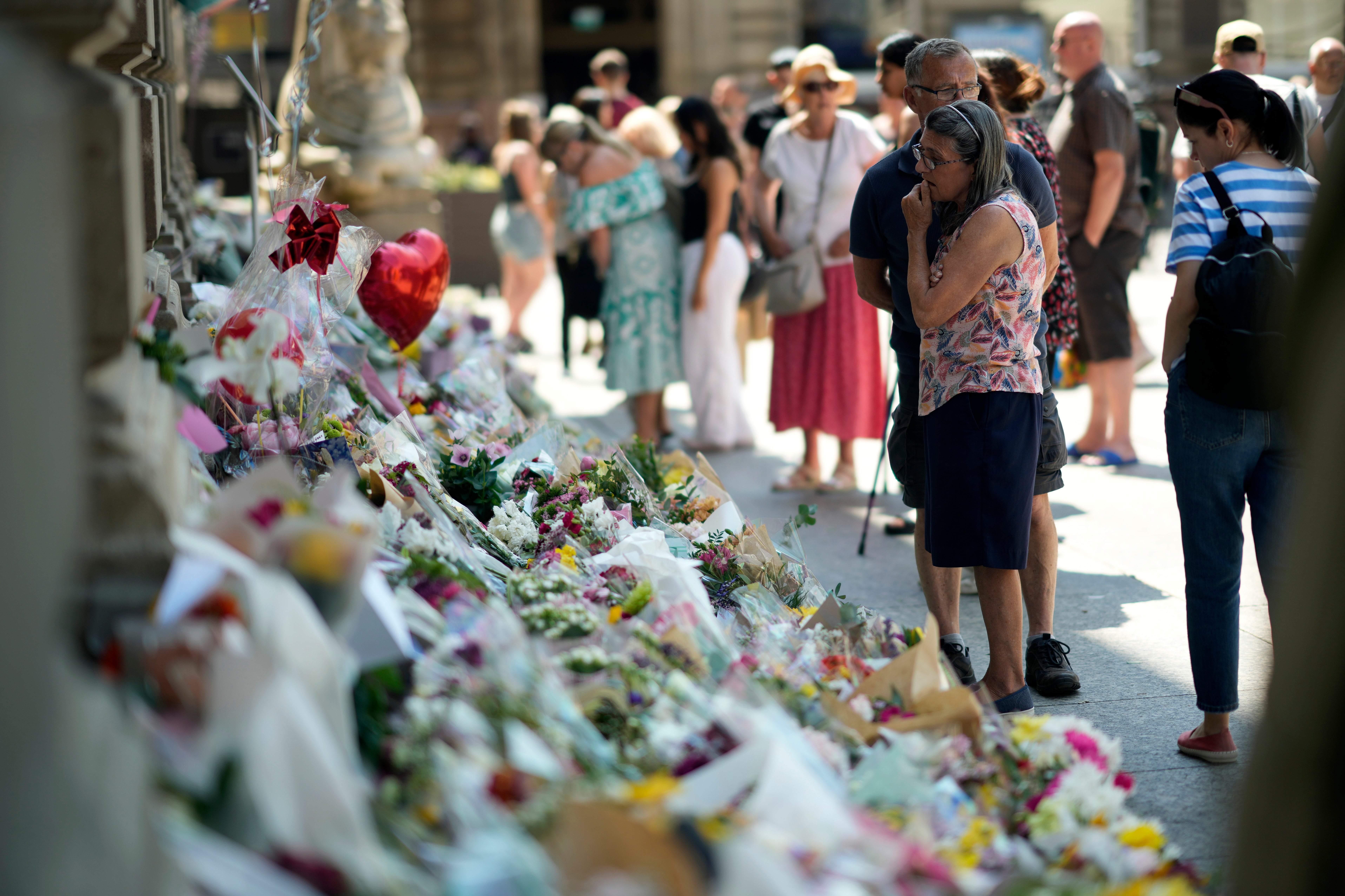 Flowers, balloons and tributes lay on the steps of Nottingham Council House after three people were killed and another three hurt in Tuesday's attacks