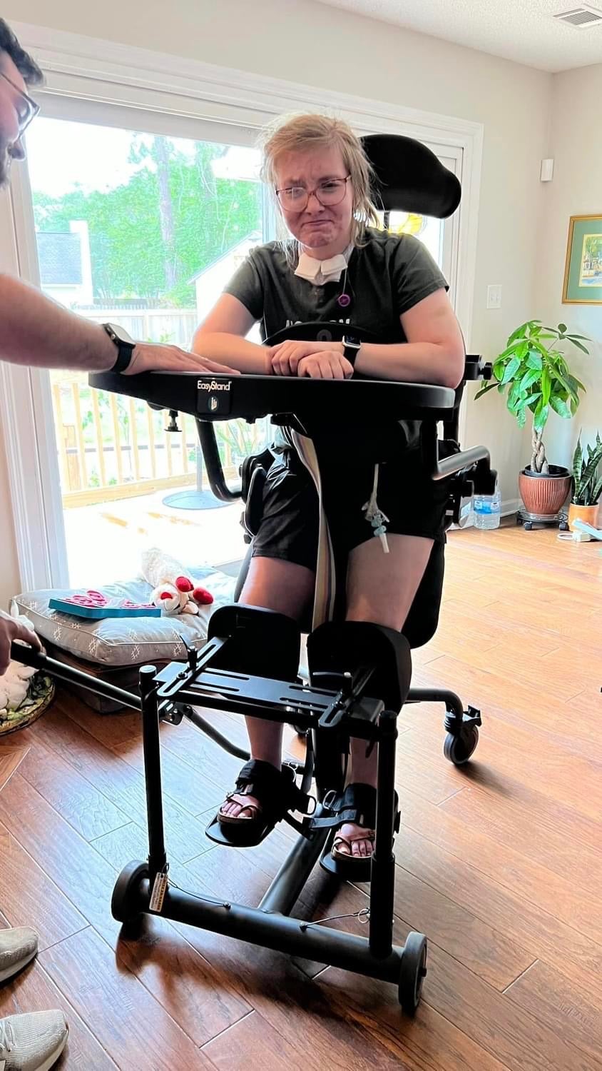 Caitlin practices at home with a loner standing frame, which is ‘tremendously helpful to her recovery’ and which her mother is attempting to get insurance to help finance