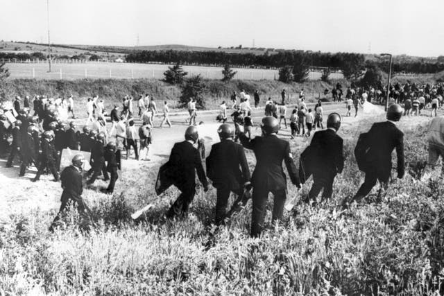 Police in anti-riot gear escorting picketers away from their position near the Orgreave Coking Plant near Rotherham (PA)