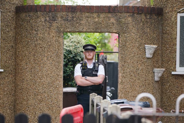 <p>Police at the scene in Bedfont, Hounslow where a three-year-old boy and a girl, 11, are among four people who have been found dead in a flat in west London</p>