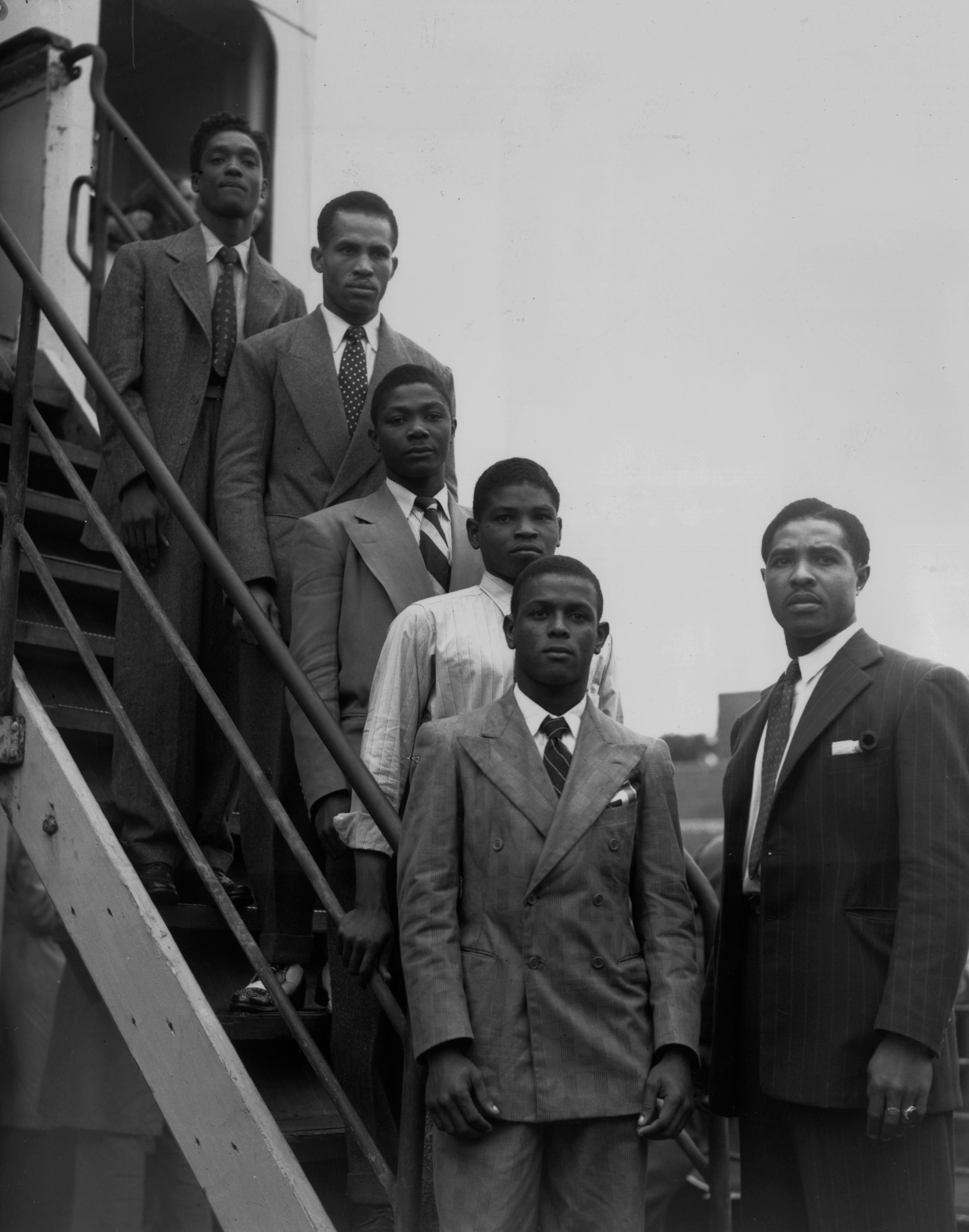 From the top, hopeful Jamaican boxers Charles Smith, Ten Ansel, Essi Reid, John Hazel, Boy Solas and manager Mortimer Martin arrive at Tilbury on the Empire Windrush