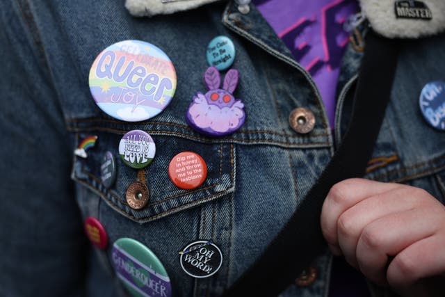 <p>Badges are seen on a protester  outside The Oxford Union on 30 May 2023 in Oxford, England</p>