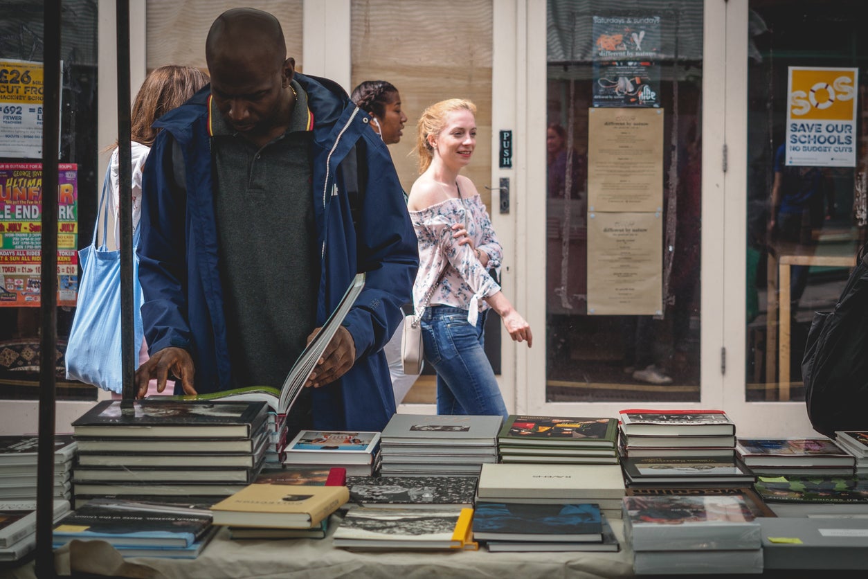Amid the street food, stalls sell vintage books in Broadway Market, Hackney