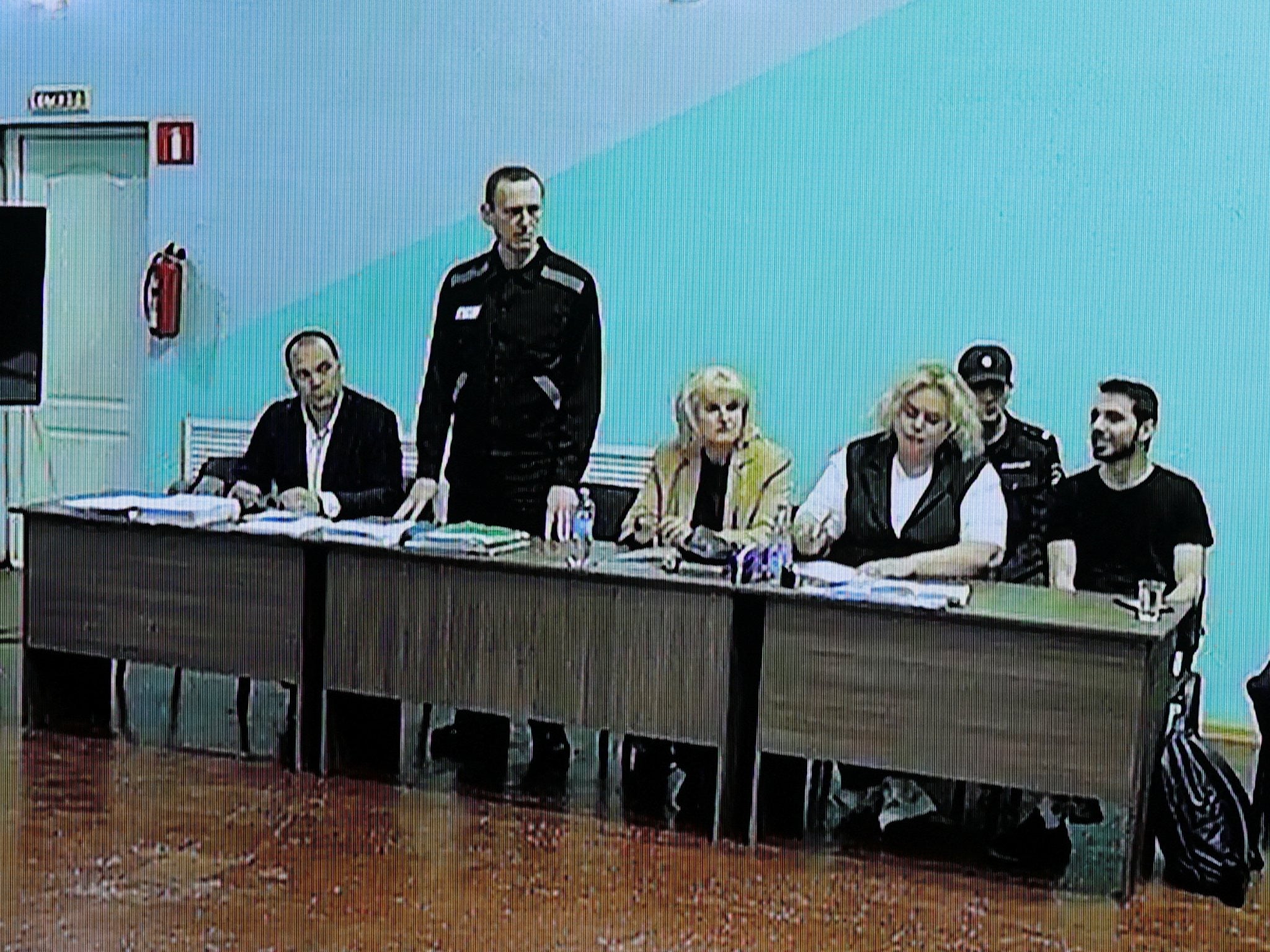 Alexei Navalny, standing, with his lawyers during the hearing at Moscow City Court