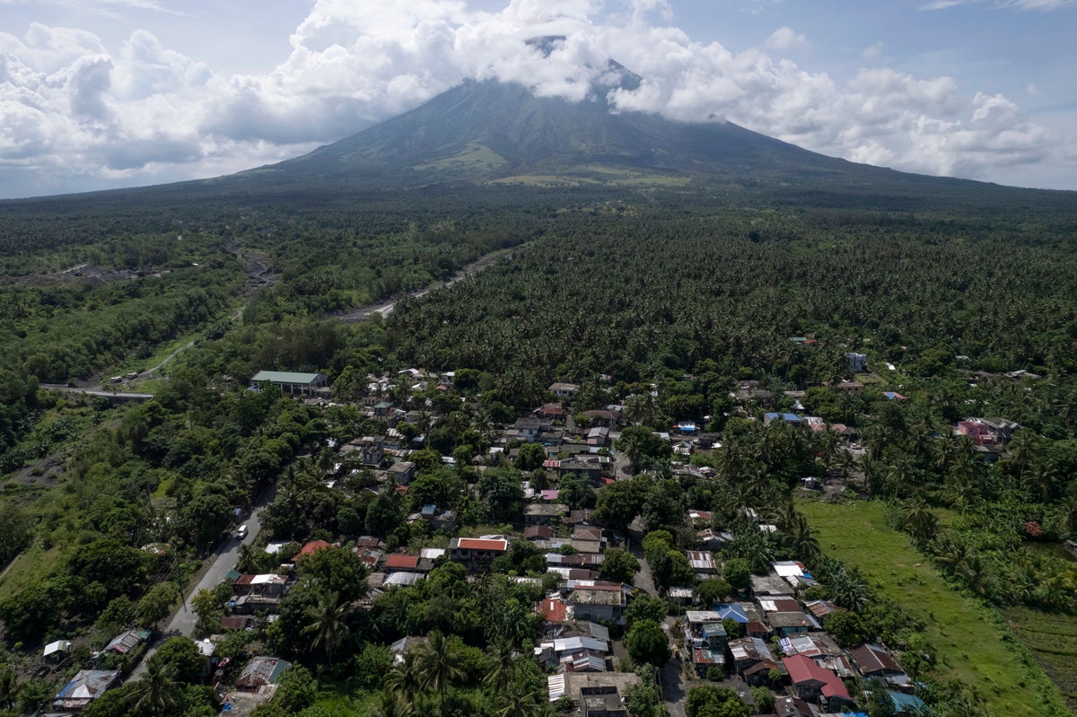 Poor villagers risk their lives in danger zone as Philippines’ most active volcano erupts