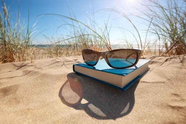 Pick up one of these romance novels for your next holiday (Alamy/PA)
