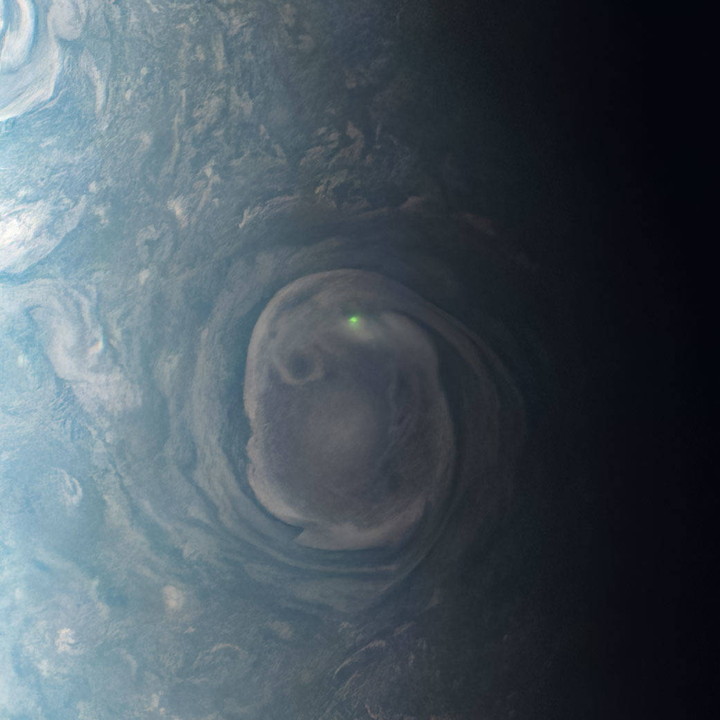 NASA’s Juno mission captured the green glow from a bolt of lightning above the planet