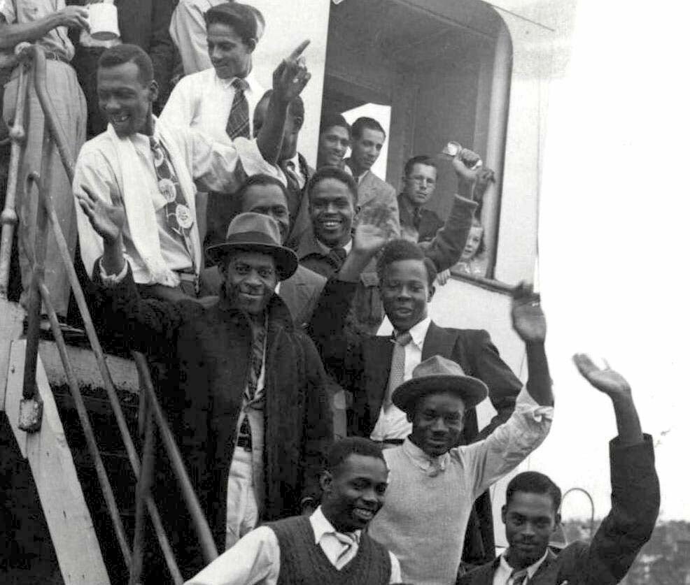 Jamaicans get their first look at Britain as they arrive on the Windrush at Tilbury Docks on 22 June 1948