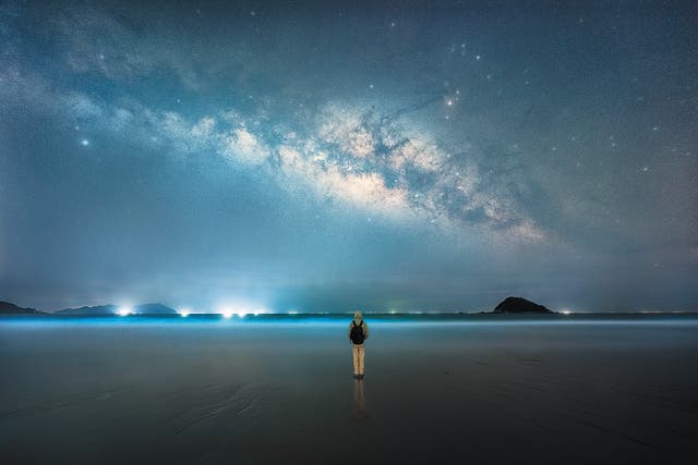 <p>A night visitor to Xichong Beach in Shenzhen, Guangdong province, appreciates the sky</p>