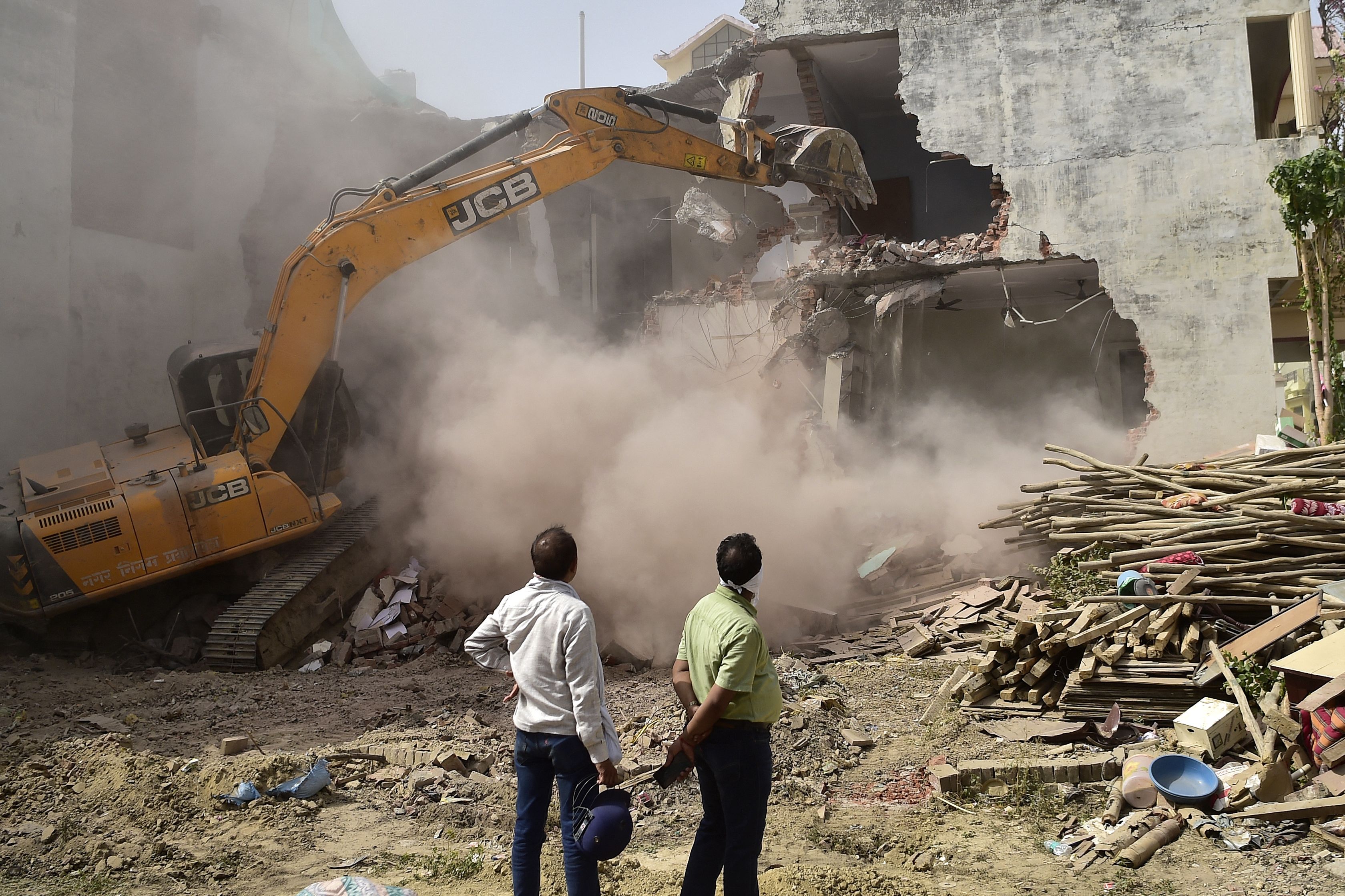 In this file photo taken on 12 June 2022, a bulldozer demolishes the house of a local leader allegedly involved in recent violent protests against Bharatiya Janata Party’s (BJP) former spokesperson Nupur Sharma's incendiary remarks about Prophet Mohammed in Allahabad