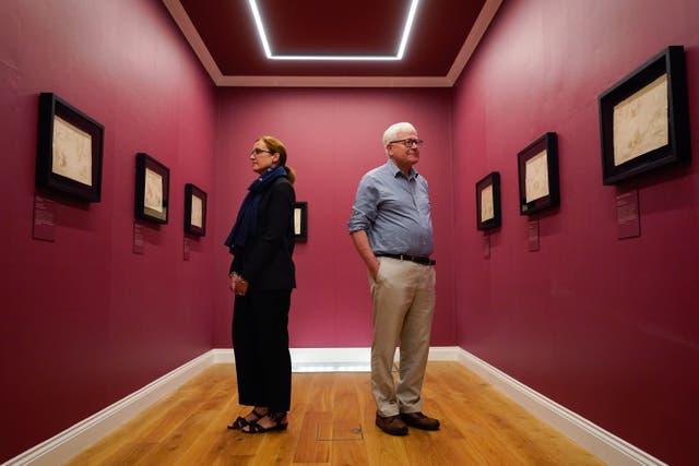 The National Museum of the Royal Navy’s director general, professor Dominic Tweddle (right), and head of collections and research, Louisa Blight, admire the maps ((Andrew Matthews/PA)