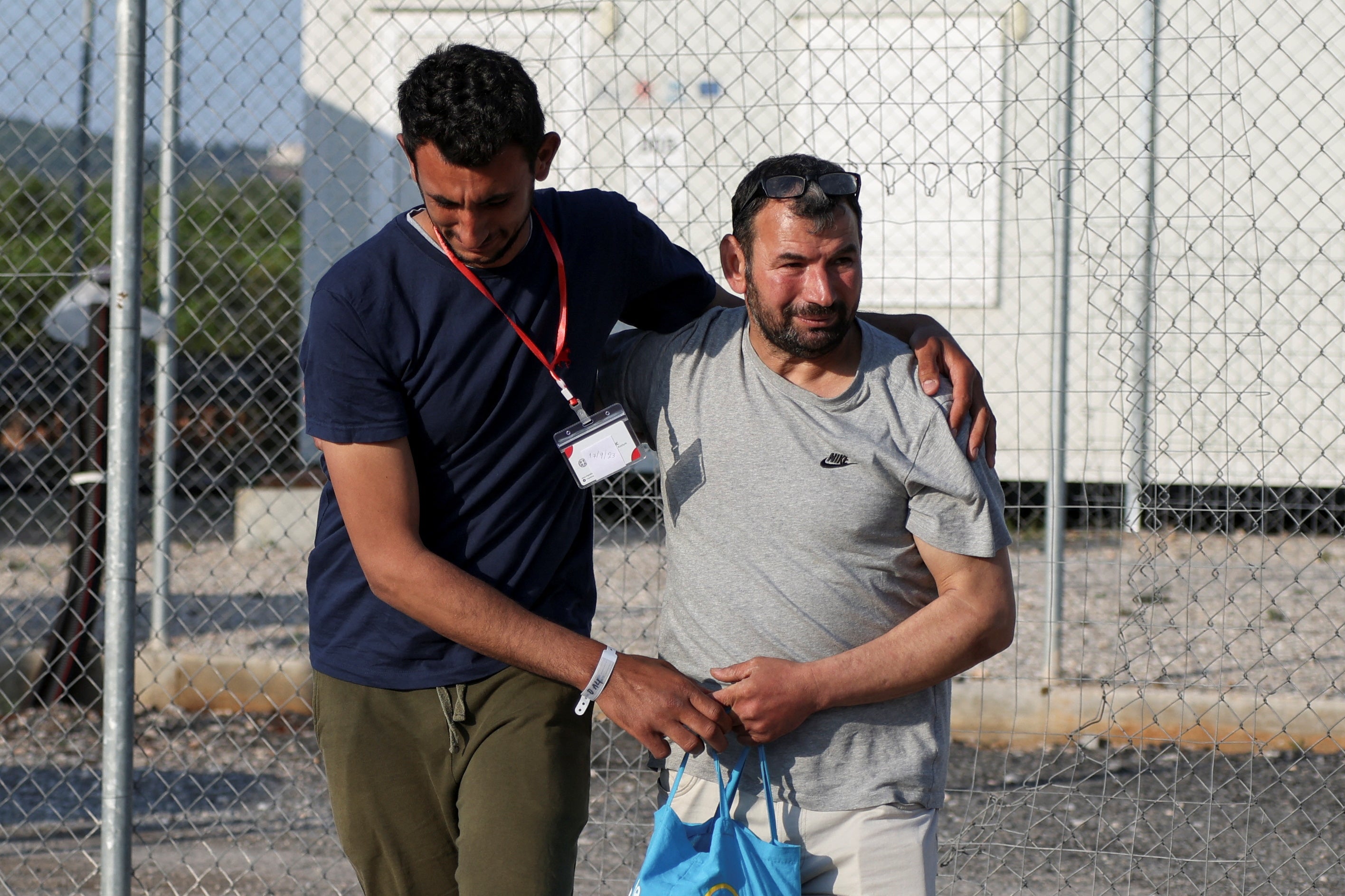 Egyptian survivor Atia Al Said, 22 is reunited with his uncle Mohamed El Sayed El-Dadamony Radwan, 54, at a Greek migrant facility