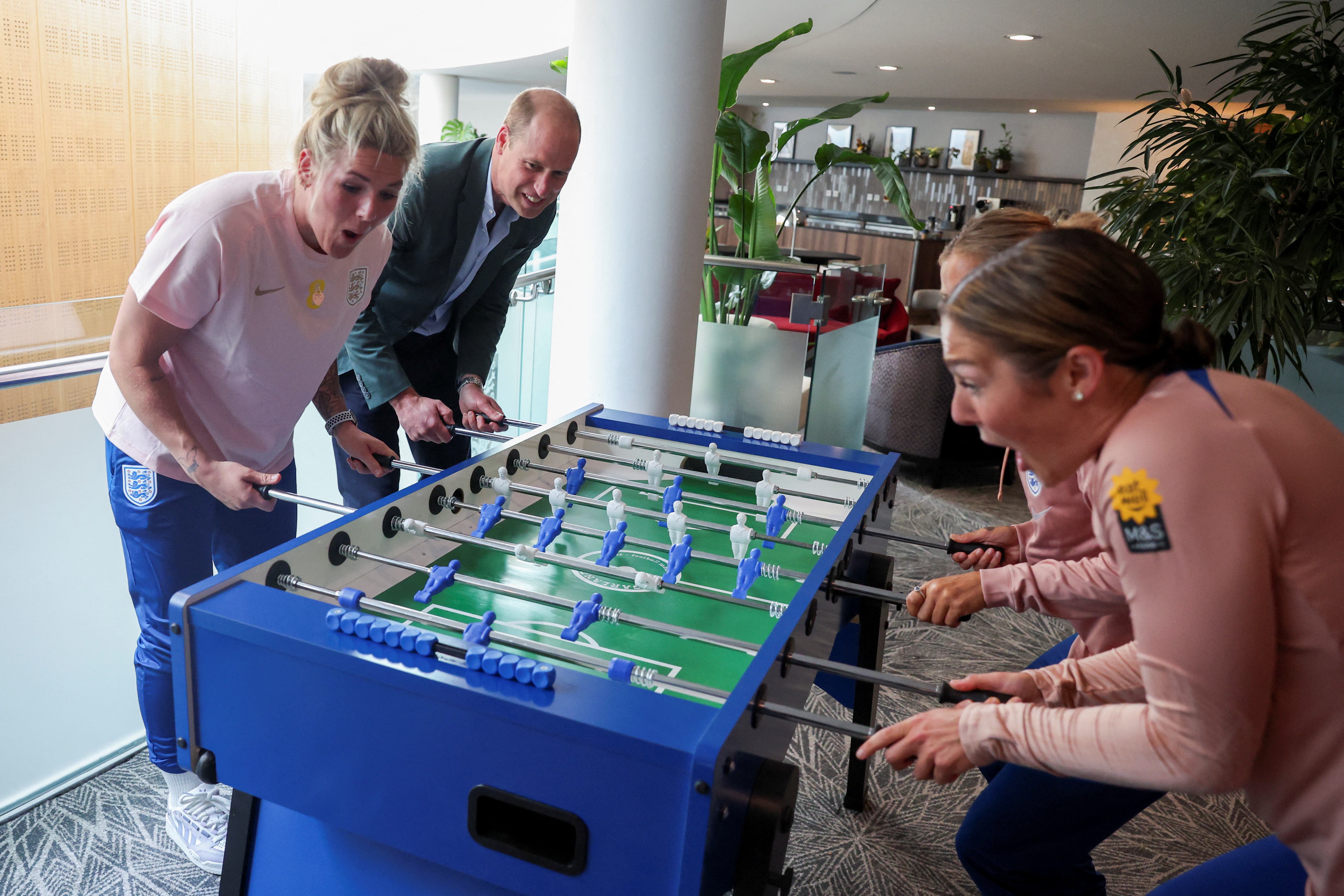 The Prince of Wales plays table football with members of England Women’s football team (Phil Noble/PA)