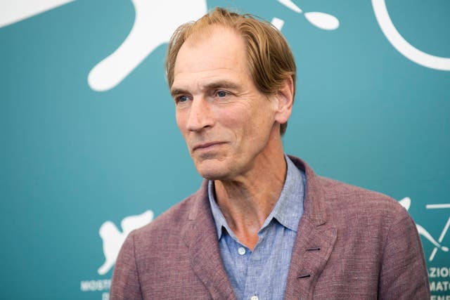 <p>Actor Julian Sands poses for photographers at the Venice Film Festival in 2019</p>