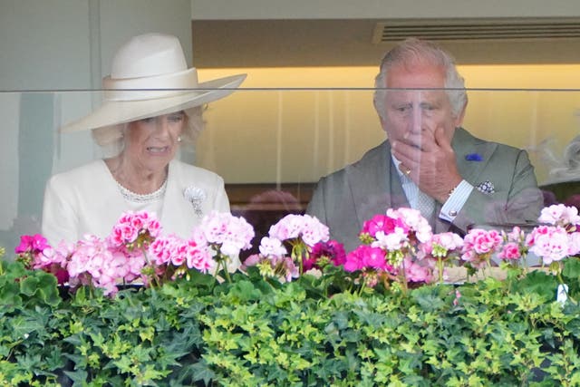 Camilla and Charles watch on as their horse Saga races in the Wolferton Stakes (Jonathan Brady/PA)