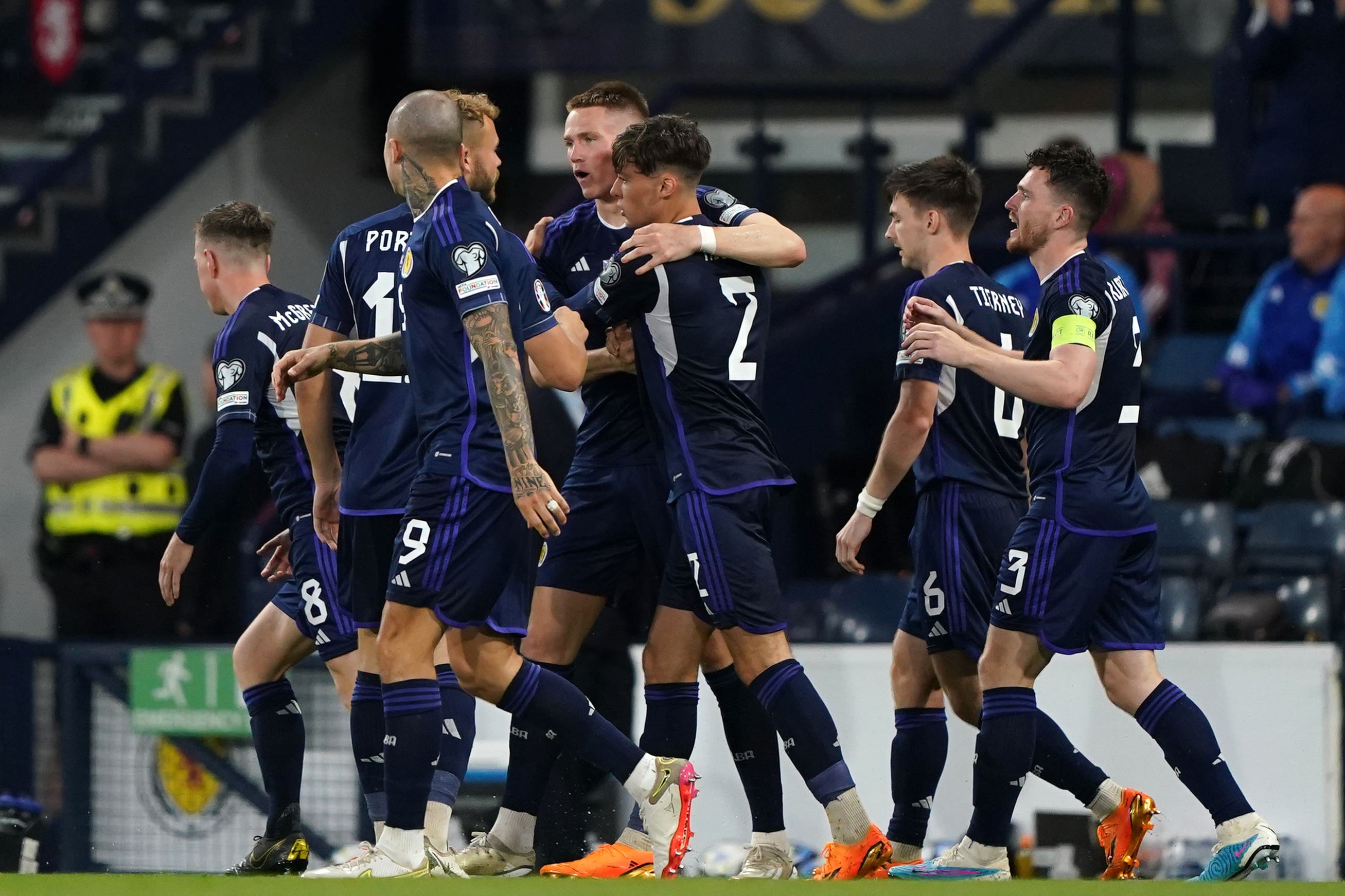 Scott McTominay (centre) celebrates scoring Scotland’s second goal (Andrew Milligan/PA)