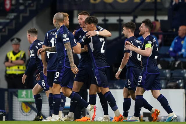 Scott McTominay (centre) celebrates scoring Scotland’s second goal (Andrew Milligan/PA)
