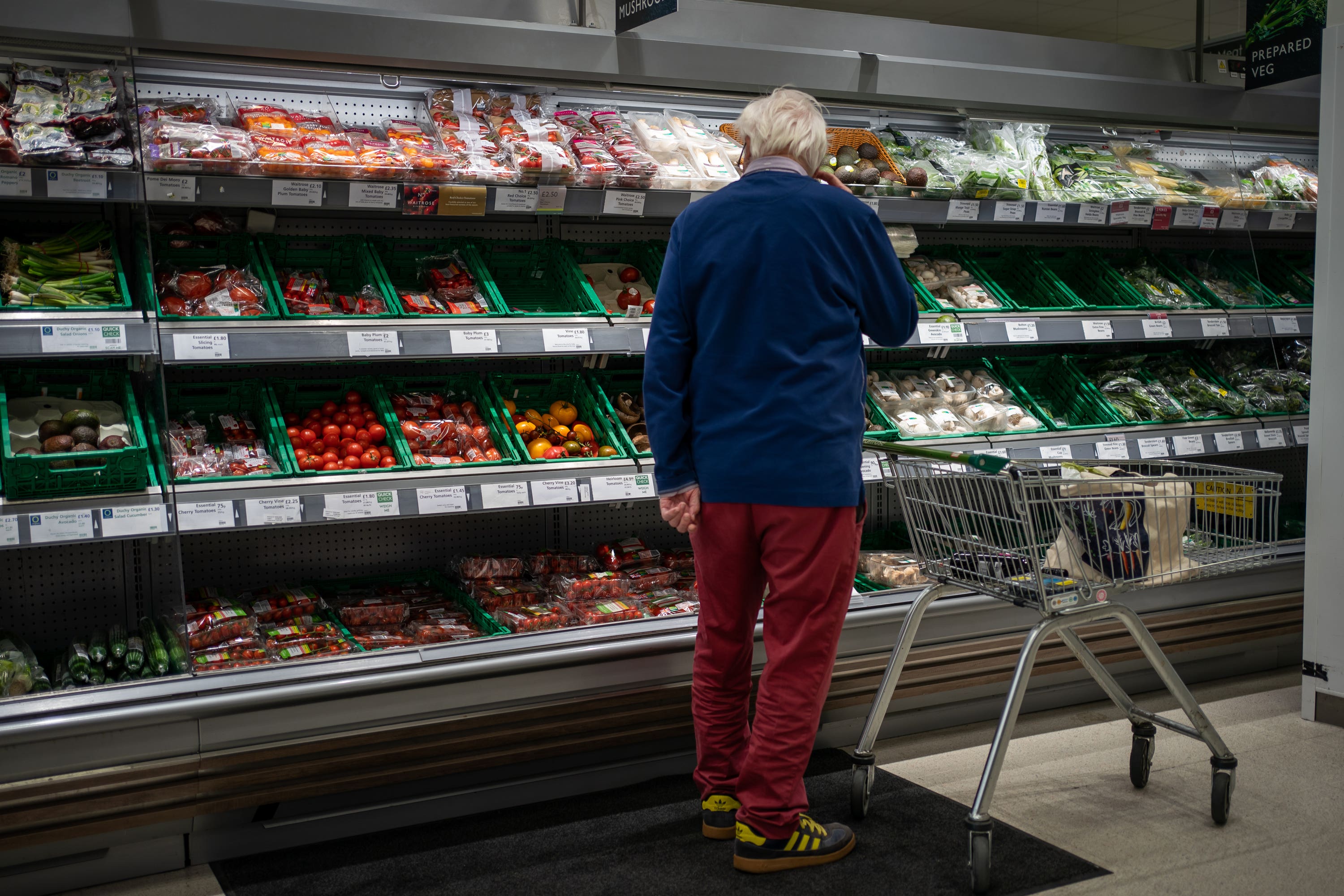 A shopper looks at salad vegetables in a branch of Waitrose (Aaron Chown/PA)