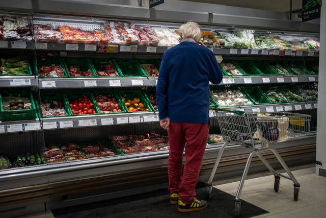 A shopper looks at salad vegetables in a branch of Waitrose (Aaron Chown/PA)