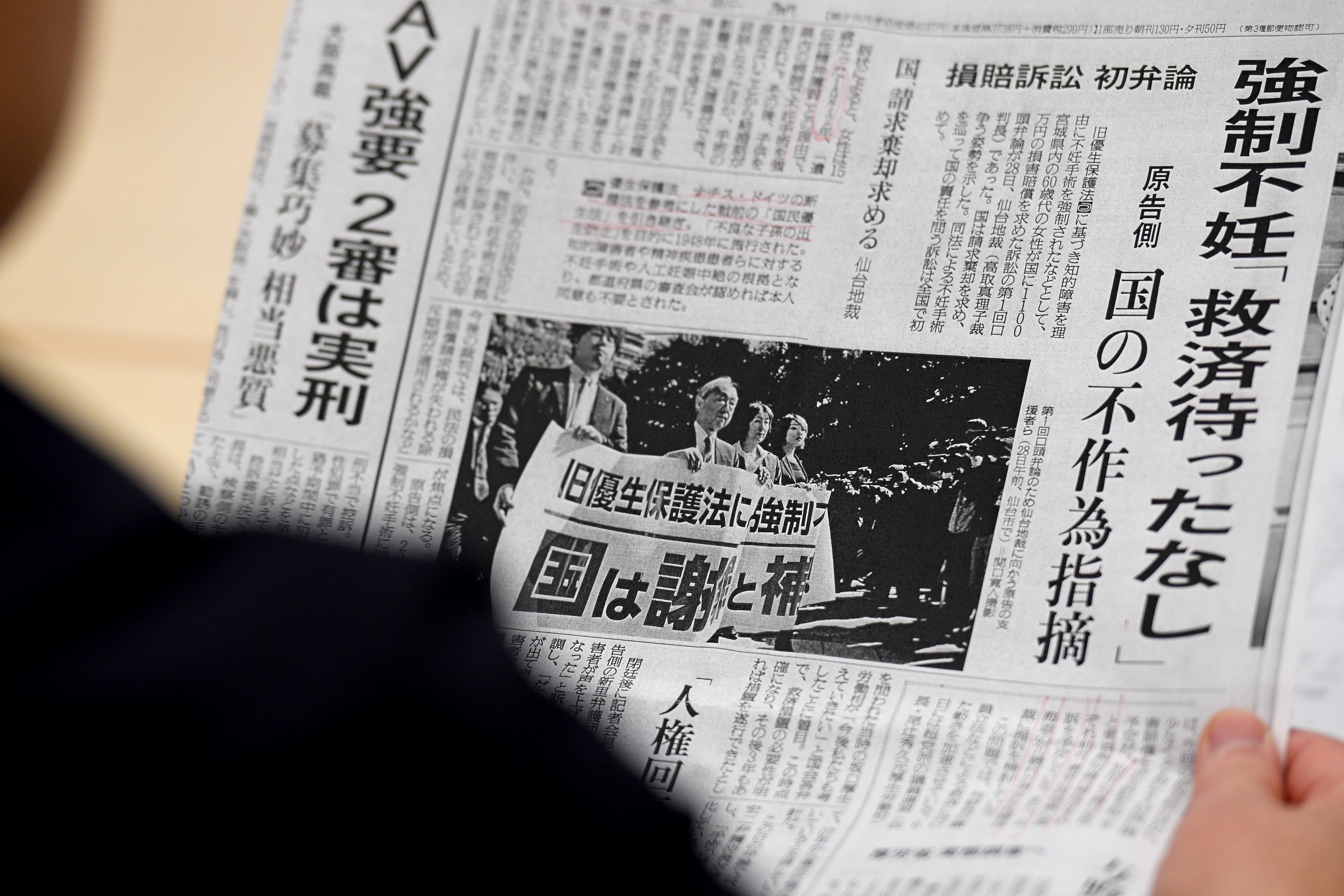 Photo from 2018 shows Michiko Sato, sister-in-law of Yumi Sato, who was sterilised as a teenager, reading a newspaper prior to a meeting with lawmakers in Tokyo